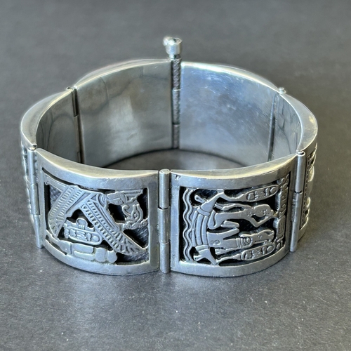 127 - An Egyptian white metal bracelet, is does bear stamp marks on three of the sections, weight approx. ... 