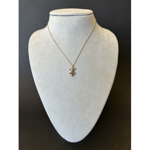 140 - A 9ct gold and orange stone set pendant and chain, total weight approx. 1.9g (the chain has an as fo... 