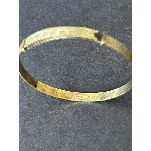143 - A small selection of vintage costume jewellery including a rolled gold childs bangle, stone pendants... 