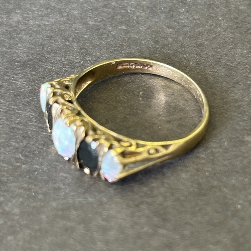 172 - A 9ct gold opal and dark stone ring, approx. size T, weight approx. 3.5g