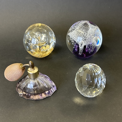 387 - Three vintage glass paperweights plus a purple glass atomiser perfume bottle