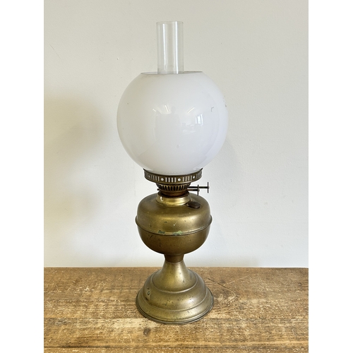 390 - A vintage duplex brass base oil lamp with white glass shade and chimney, approx. 20