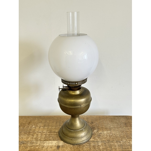 390 - A vintage duplex brass base oil lamp with white glass shade and chimney, approx. 20