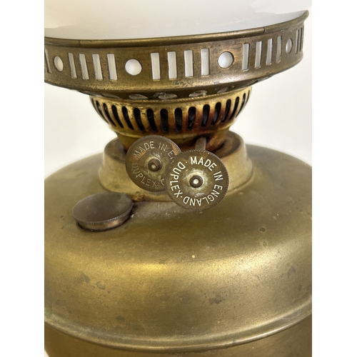 390 - A vintage duplex brass base oil lamp with white glass shade and chimney, approx. 20