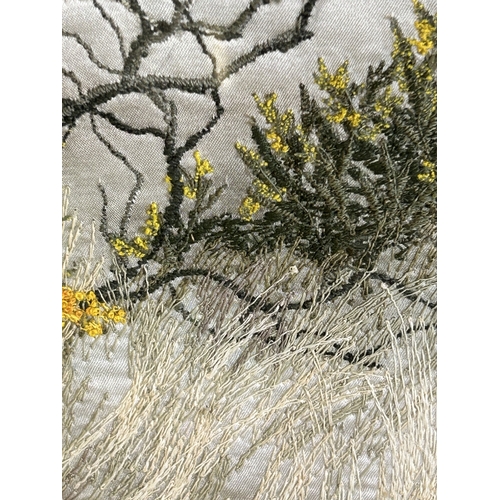 417 - A framed and glazed silk work picture of a tree in a landscape, initialled J D, 17