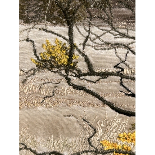 417 - A framed and glazed silk work picture of a tree in a landscape, initialled J D, 17