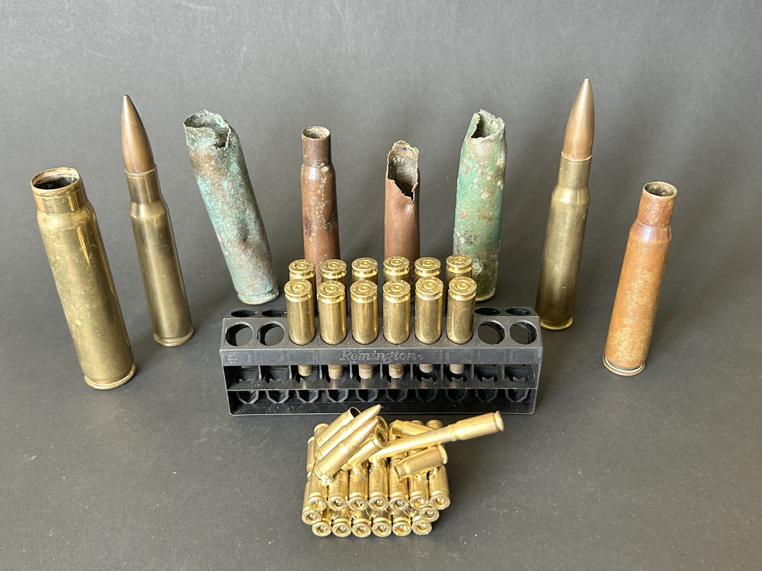 A mixed lot of rifle shells, a model of a tank made from small pistol ...