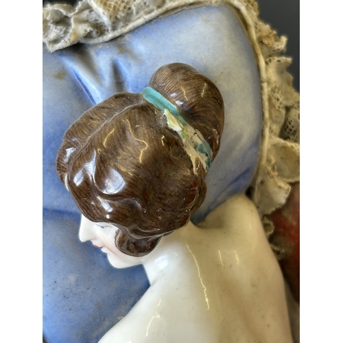 82 - A vintage Dresden porcelain lacework recumbent female figurine, bears a blue crown mark to the back,... 