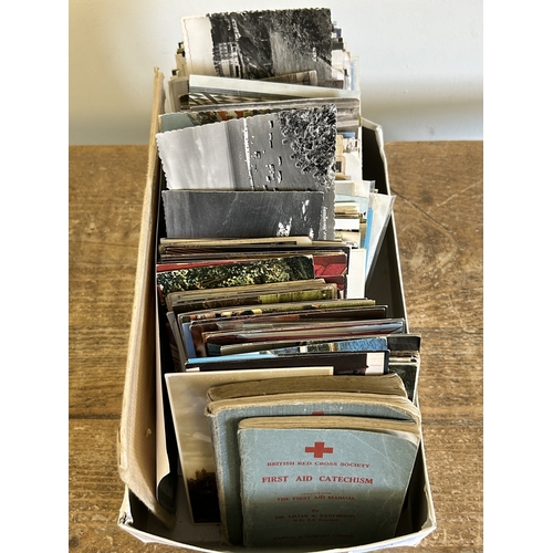 91 - A selection of vintage postcards and Red Cross First Aid books