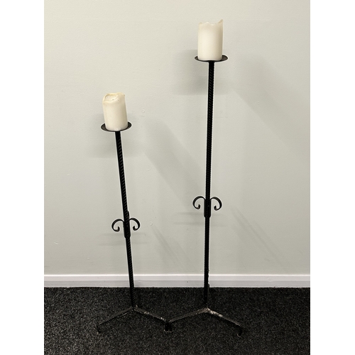 476 - Two tall iron candle holders, the tallest approx. 40 1/2