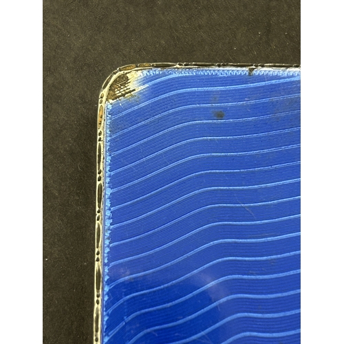 136 - A hallmarked silver and blue enamel cigarette case, just over 3
