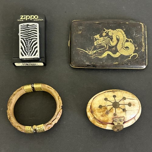 193 - A vintage small box constructed from bone, a carved wooden bangle with elephants and lions, an Orien... 