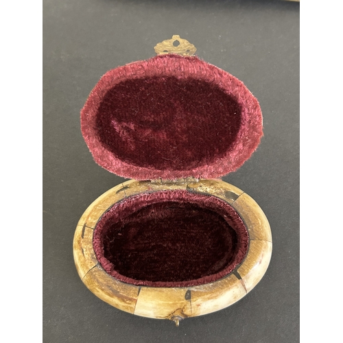 193 - A vintage small box constructed from bone, a carved wooden bangle with elephants and lions, an Orien... 