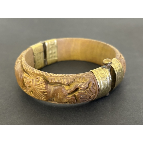 193 - A vintage small box constructed from bone, a carved wooden bangle with elephants and lions, an Orien... 