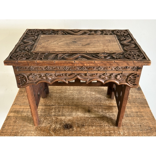 252 - An antique Chinese portable wooden fold-up scribe or reading table decorated with dragons to the top... 