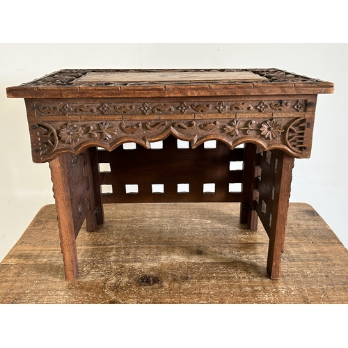252 - An antique Chinese portable wooden fold-up scribe or reading table decorated with dragons to the top... 