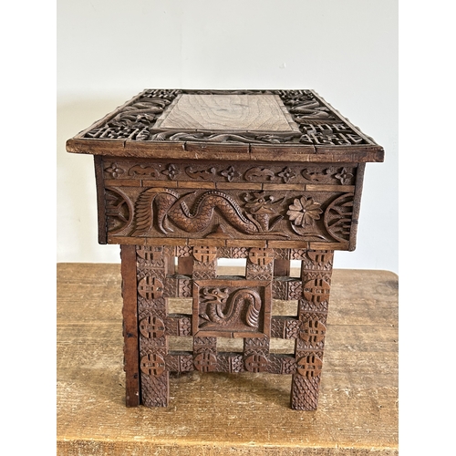 252 - An antique Chinese portable wooden fold-up scribe or reading table decorated with dragons to the top... 