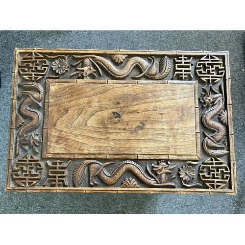 252 - An antique Chinese portable wooden fold-up scribe or reading table decorated with dragons to the top... 