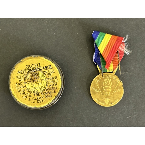 304 - A 'Dodo Design Ltd' sign with German writing, an anti dimming kit for a gas mask, a 37mm case, a 50t... 