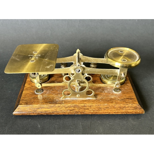 84 - A set of vintage brass postal scales on an oak base with weights