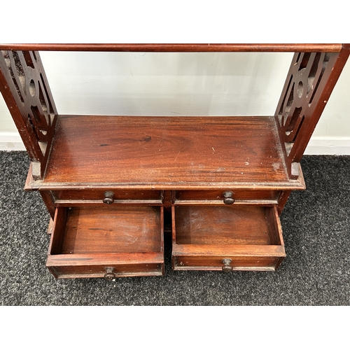 407 - A decorative mahogany shelf unit with four small drawers at the base, 44