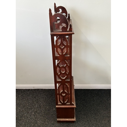 407 - A decorative mahogany shelf unit with four small drawers at the base, 44