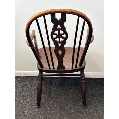 409 - An antique wheel back carver chair, back height 33 1/2