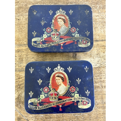 426 - A vintage stamp album with world contents together with two 1953 Coronations tins with stamps and a ... 