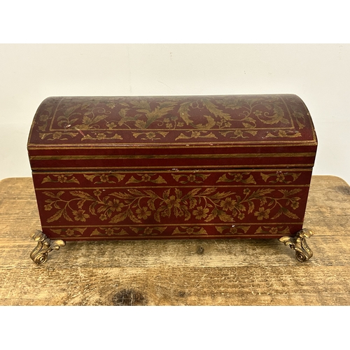 418 - A decorative 'Past Times' red and gold coloured dome top box on four gilded feet, approx. 15 1/2