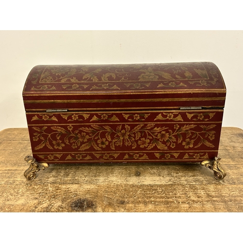 418 - A decorative 'Past Times' red and gold coloured dome top box on four gilded feet, approx. 15 1/2