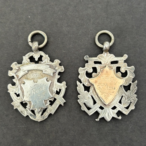 115 - Two hallmarked silver swimming prize fob medals, both named to G Rose, circa 1901/02, combined weigh... 
