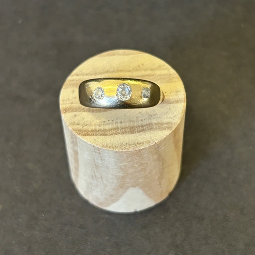 128 - A vintage yellow metal ring with three diamonds, approx. size N 1/2, weight approx. 5g