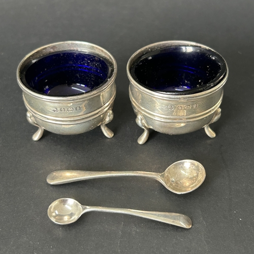 145 - A pair of hallmarked silver salts with blue glass liners together with two hallmarked silver salt sp... 