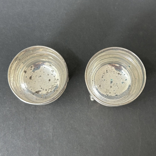145 - A pair of hallmarked silver salts with blue glass liners together with two hallmarked silver salt sp... 