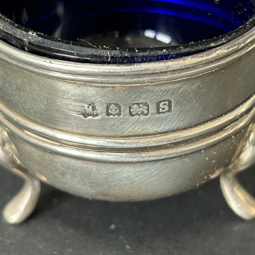 145 - A pair of hallmarked silver salts with blue glass liners together with two hallmarked silver salt sp... 