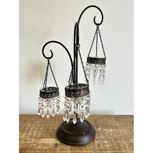 223 - A metal frame with three staggered height tealight holders, approx. 18 1/4