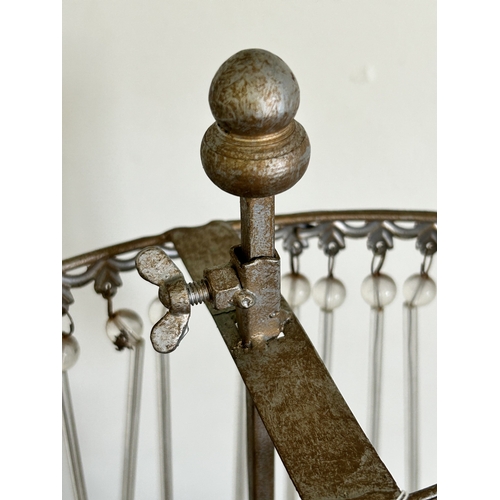 223 - A metal frame with three staggered height tealight holders, approx. 18 1/4