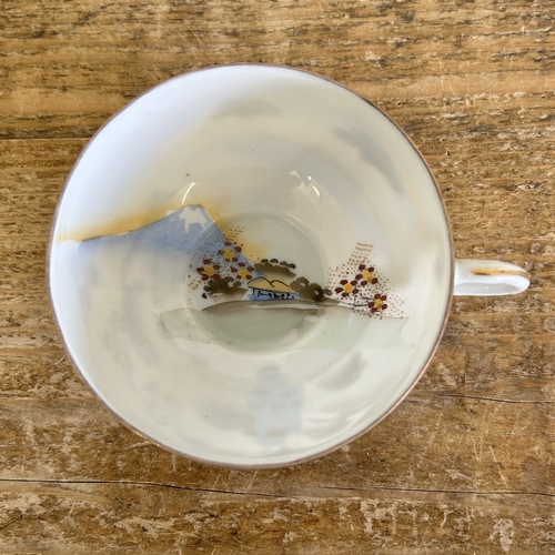 23 - A vintage Japanese porcelain tea set with hand painted decoration in a 12 setting including a teapot... 