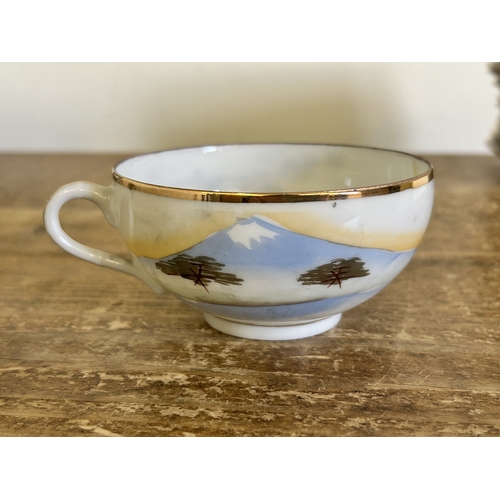 23 - A vintage Japanese porcelain tea set with hand painted decoration in a 12 setting including a teapot... 