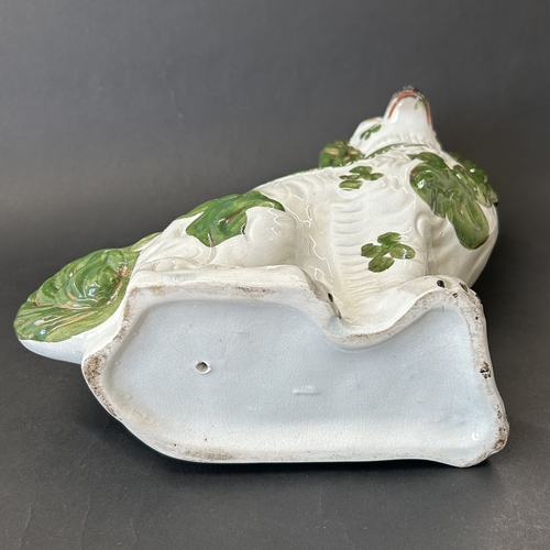 261 - A Staffordshire green pattern dog, approx. 12