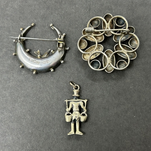 303 - A hallmarked silver crescent shape brooch with bird together with an 835 grade mini figure and an 83... 
