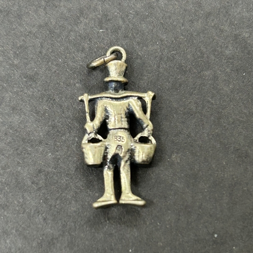 303 - A hallmarked silver crescent shape brooch with bird together with an 835 grade mini figure and an 83... 