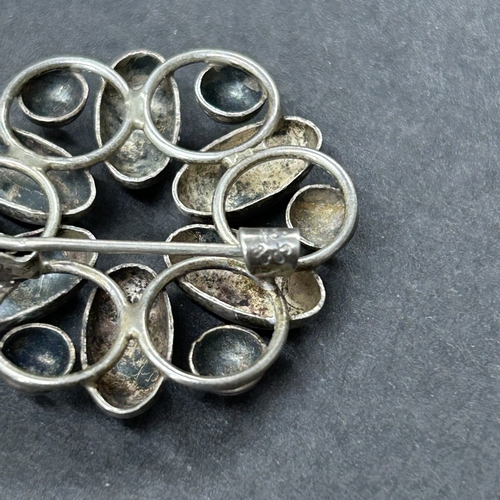 303 - A hallmarked silver crescent shape brooch with bird together with an 835 grade mini figure and an 83... 