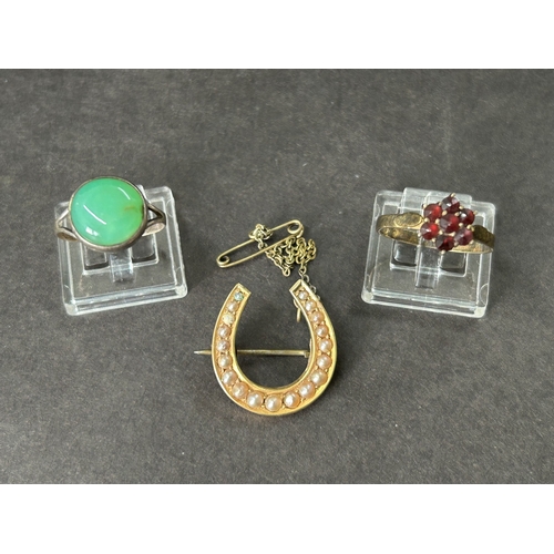 330 - A yellow metal pearl style set horseshoe brooch together with a yellow metal and red stone set ring ... 