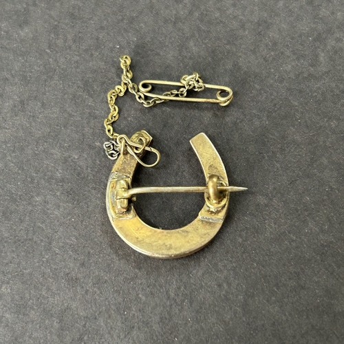 330 - A yellow metal pearl style set horseshoe brooch together with a yellow metal and red stone set ring ... 