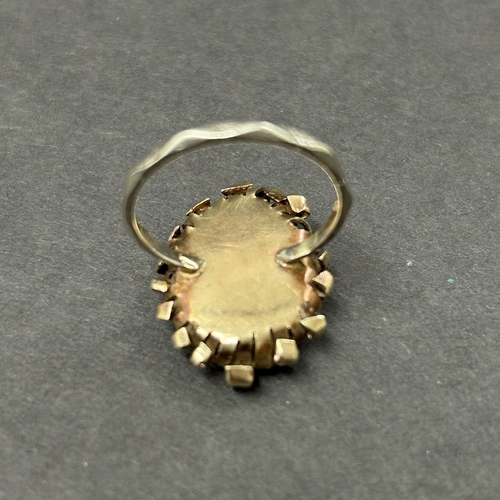 344 - An unusually constructed ring, the shank marked for 9ct white gold, the top with scrolls of yellow m... 