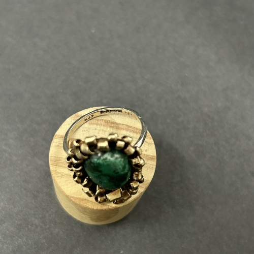 344 - An unusually constructed ring, the shank marked for 9ct white gold, the top with scrolls of yellow m... 