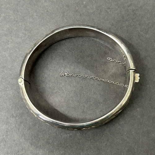 362 - A Chester hallmarked silver bangle, weight approx. 25g (safety chain as found, a few shallow dents)