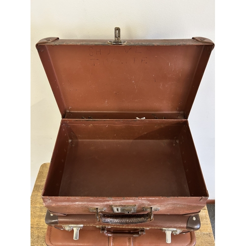 37 - Two vintage leather style small suitcases plus a leather briefcase (with age related wear)
