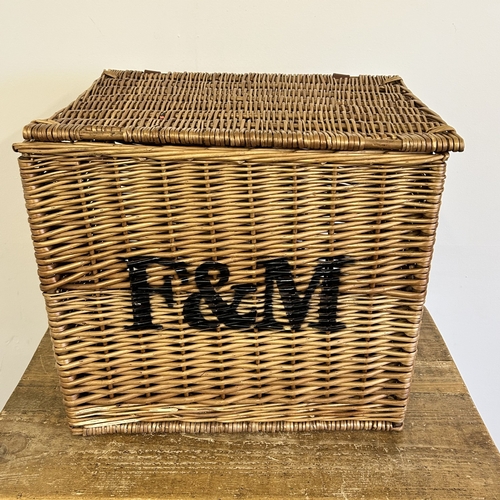 46 - A wicker lidded box stencilled 'F & M' to the front, approx. 16 1/2